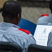 Past participants of the DICE program hold their certificates on the final day of training. 