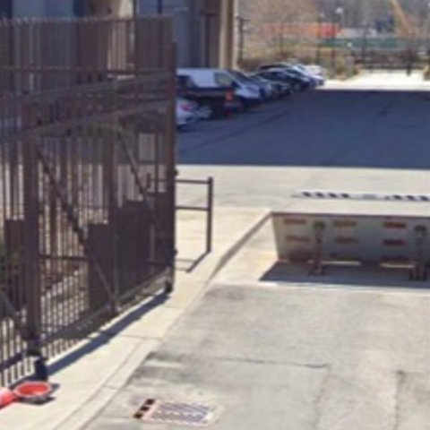 Figure depicting an open gate to a parking area