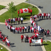 Aerial group picture of RCMP employees wearing red and white