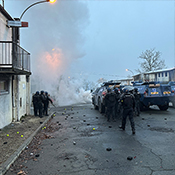 Groups of officers arrive at a fire scene in a small town.