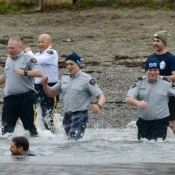 RCMP members run into a lake