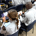Cadets holding their Silent Partner Cards.