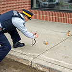 Cadet documents his observations of the crime scene and the evidence in his notebook.