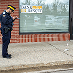 Cadet photographs the scene and the evidence prior to disturbing the crime scene.