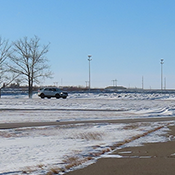 Police cars drive on a track on a winter day.