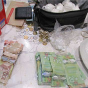 Canadian currency and drugs splayed out on a counter.