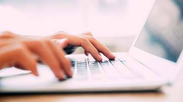 hands typing on keyboard