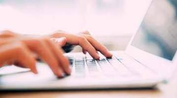 hands typing 'report a crime' on a keyboard