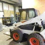 Bobcat skid-steer loader located and seized during the execution of the search warrant.