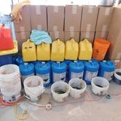 Boxes and containers of chemicals utilized to produce MDMA located within the synthetic drug lab