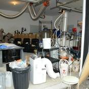 2 RCMP CLEAR team members processing and dismantling the synthetic drug laboratory