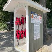 Kids Don’t Float life jacket loaner station stocked with various sizes of life jackets