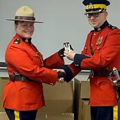 Rosanne Komlos receives certificate from Inspector Gillespie receives award presented by Inspector Gillespie