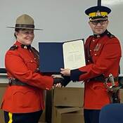 Rosanne Komlos receives certificate from Inspector Gillespie