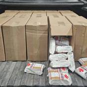 A large quantity of unstamped cigarettes were discovered concealed inside cardboard boxes during a vehicle inspection.