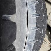 A commercial vehicle tire with an 8-inch gash.