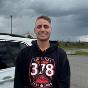Buddy Rhodes smiling under a grey sky