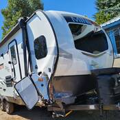 A white Minilite trailer that was being towed by a black GMC Denali pickup when there was a fatal collision in Fanny Bay