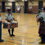 S/Sgt. John Llambias and members of the youth teaching program play their instruments.