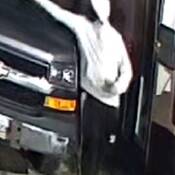 Front view of suspect wearing light hoody and dark pants with stripe