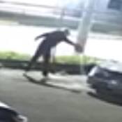 Silhouette of suspect, standing and bent over at waist.