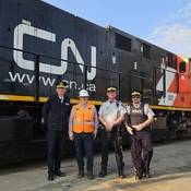 Alberta RCMP and CN Police delegates stand in front of CN train car to mark beginning of Operation Lifesaver's Rail Safety Week.