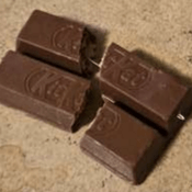 Photo of small chocolate bar with sewing needle