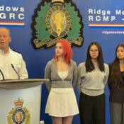 Ridge Meadows RCMP Insp. Martin Guay with Indiana Gerard, Chloe He, and Sophia Jasemianaasl at award ceremony.