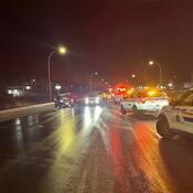 A wintery checkstop in Prince George, with BC Highway Patrol vehicles in the foreground as vehicles are stopped in the background
