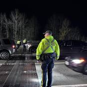 Police officers getting ready to check drivers for impairment