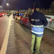 Coroner and police officers educating drivers about driving sober