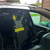 Auto‑crime alert notice seen through car window