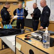 Negotiators gather and share information in a command centre during the training exercise