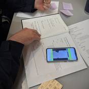 Detailed notes are taken by the negotiation team as the training scenario unfolds