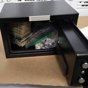 Photo of drugs and money in a safe seized by police.