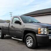A grey 2010 Chevrolet Silverado pickup truck;