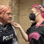 Cst Neustaeter with Rowdy Cat (Mascot) scratches painted on his head