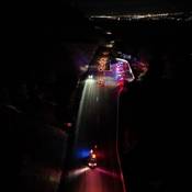 An overhead photo of BC Highway Patrol vehicles stopping traffic during an impaired driving check stop at night in Kaleden, BC