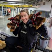 Cst Rissanen holding two collectible sasquatches