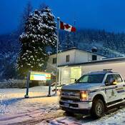 A winter photo of the Pemberton RCMP detachment with police truck parked in the driveway.