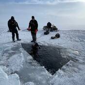 RCMP Underwater Recovery Team specialized ice divers in water at Charlotte Lake.