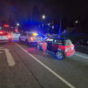 Picture of a red Mini cooper and a police vehicle
