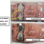 Photo comparing one of the counterfeit $50 bills with a genuine $50 bill.  Note the lack of detail in the metallic strip, and the absence of colour in the strip.