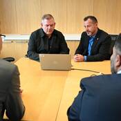 Investigators with the BC Hate Crimes Unit review a public presentation