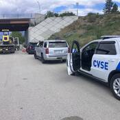 BC Highway Patrol and CVSE vehicles doing an inspection at the side of a highway during a joint enforcement operation near Kamloops