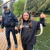 A student proudly shows the fish she caught