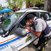 officer with child in front seat of police vehicle