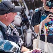 Officer with child looking through traffic laser
