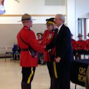 Cst. Bruce Lindsay receives his badge from his father, retired Cpl. Bruce Lindsay, at his Depot graduation ceremony in 2016.