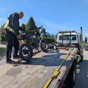 E-dirt bike on the back of a tow truck